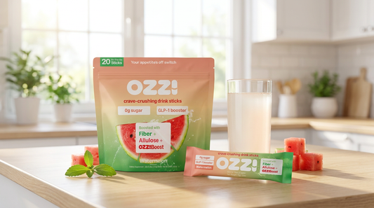 OZZ! watermelon stick pack and prepared drink on a kitchen counter with watermelon and stevia leaf