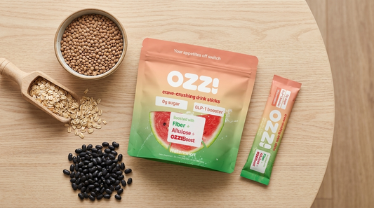 Overhead flatlay of budget GLP-1 boosting foods, lentils, oats, and beans, next to an Ozzi watermelon drink stick and pouch