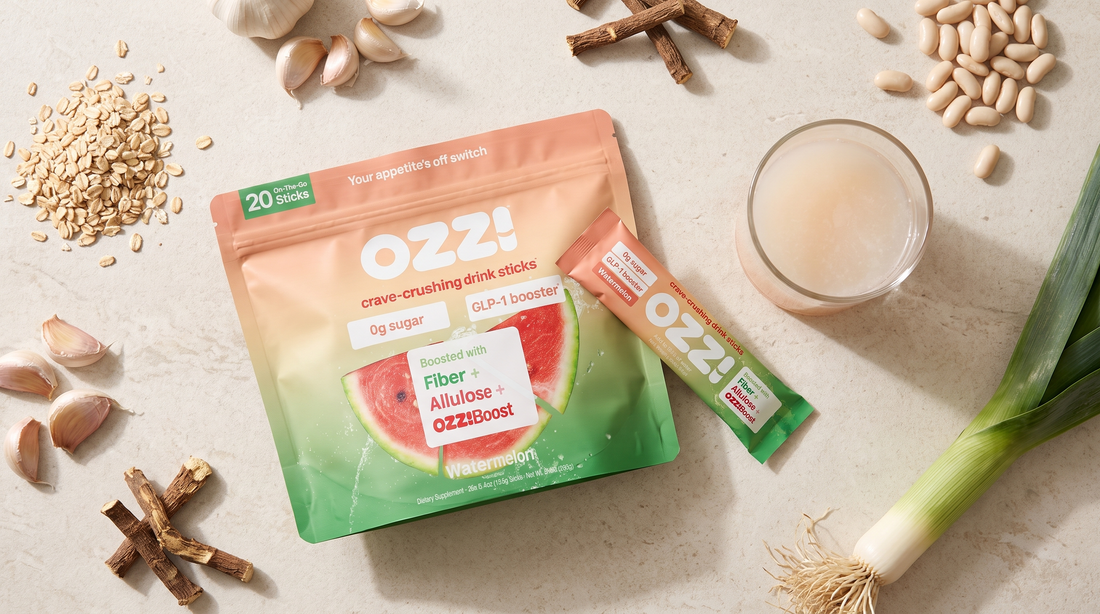 Overhead flatlay of an Ozzi watermelon pouch and stick pack surrounded by oats, garlic, chicory root, beans and leek