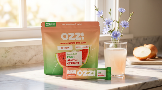 Ozzi Crave Crusher watermelon pouch and stick beside a glass of the prepared drink on a kitchen counter