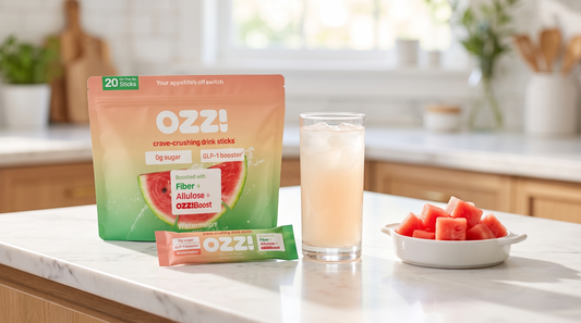Ozzi watermelon stick pack pouch, a single stick, and a glass of the prepared drink on a morning kitchen counter