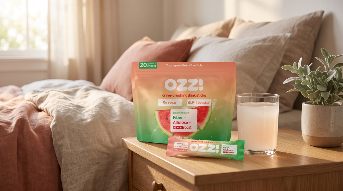 Ozzi watermelon drink stick pack, single stick, and a prepared glass of Ozzi on a bedroom nightstand in morning light