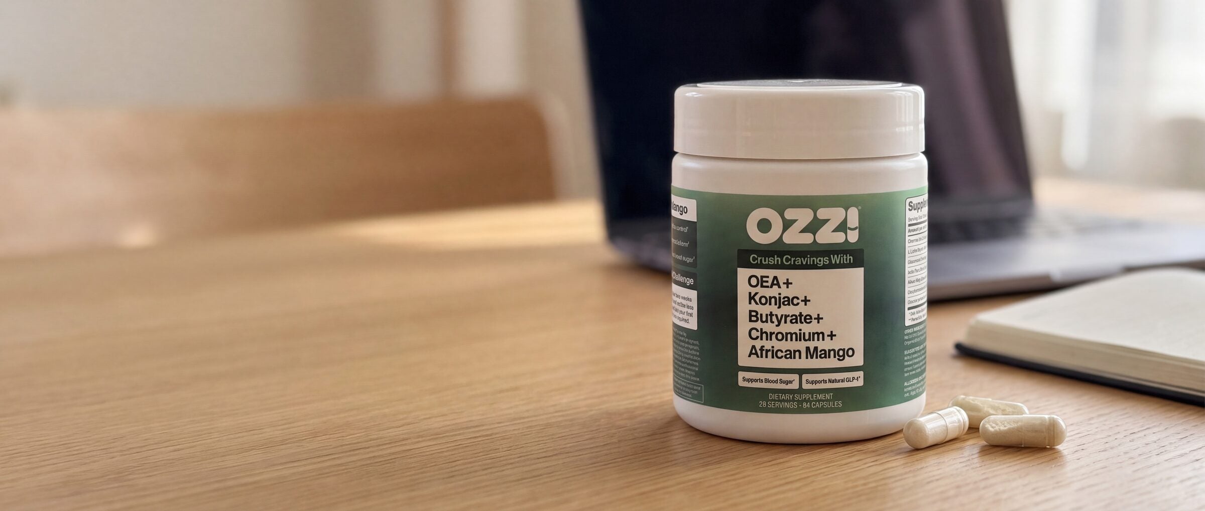 A bottle of Ozzi capsules on a wooden table